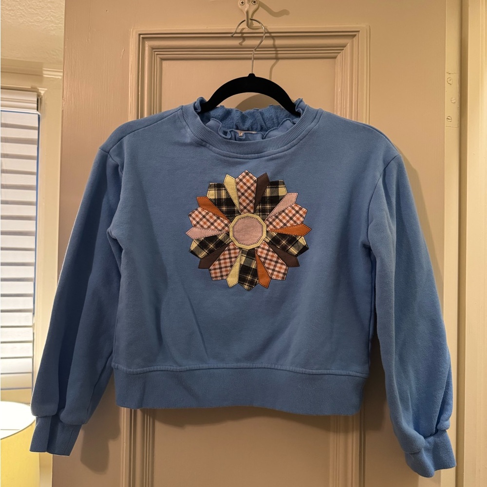 Copper Key Blue Girls’ Sweater with Ruffle Neckline and Plaid Flower Accent